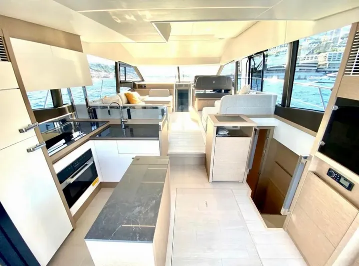  Yacht Photos Pics Luxurious interior of 2023 Prestige 520 yacht with modern kitchen and seating area.