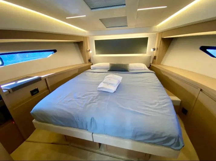  Yacht Photos Pics Luxurious bedroom interior of 2023 Prestige 520 yacht with modern design and ambient lighting.