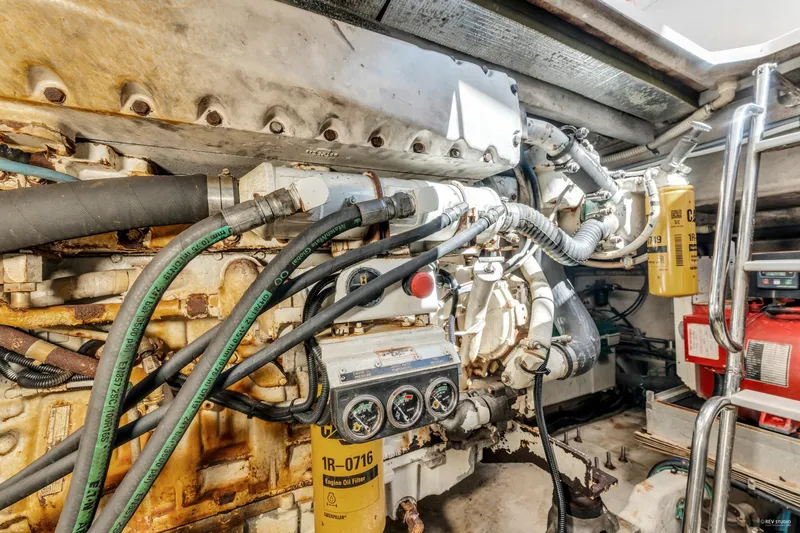  Yacht Photos Pics Engine room of a 1997 Sea Ray 500 Sundancer with visible hoses and components.