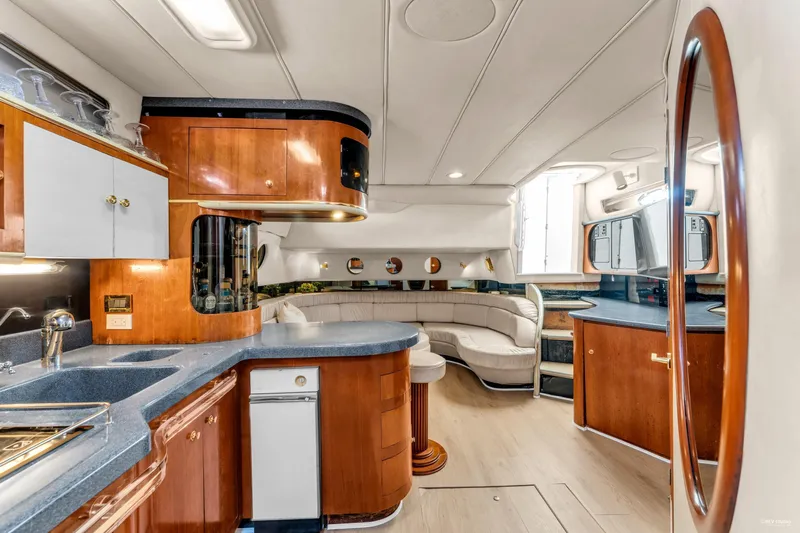  Yacht Photos Pics Luxurious interior of a 1997 Sea Ray 500 Sundancer yacht with elegant wood finishes.