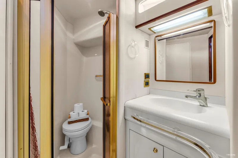  Yacht Photos Pics Bathroom interior of 1997 Sea Ray 500 Sundancer yacht, featuring sink and toilet.