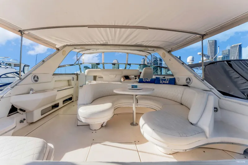 Yacht Photos Pics Luxurious 1997 Sea Ray 500 Sundancer yacht interior with white seating and city skyline view.