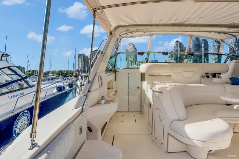  Yacht Photos Pics Luxurious 1997 Sea Ray 500 Sundancer yacht interior at marina with city skyline.