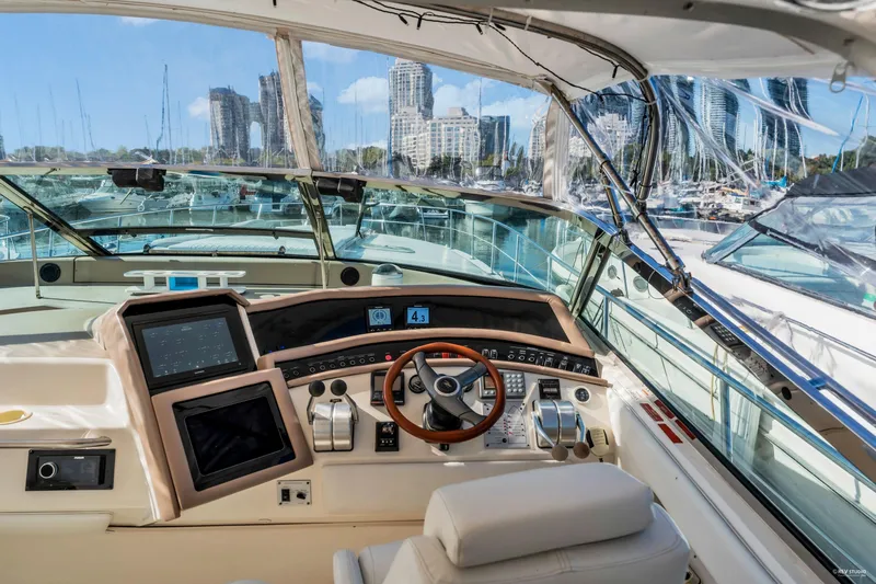  Yacht Photos Pics 1997 Sea Ray 500 Sundancer helm with modern controls and cityscape view.