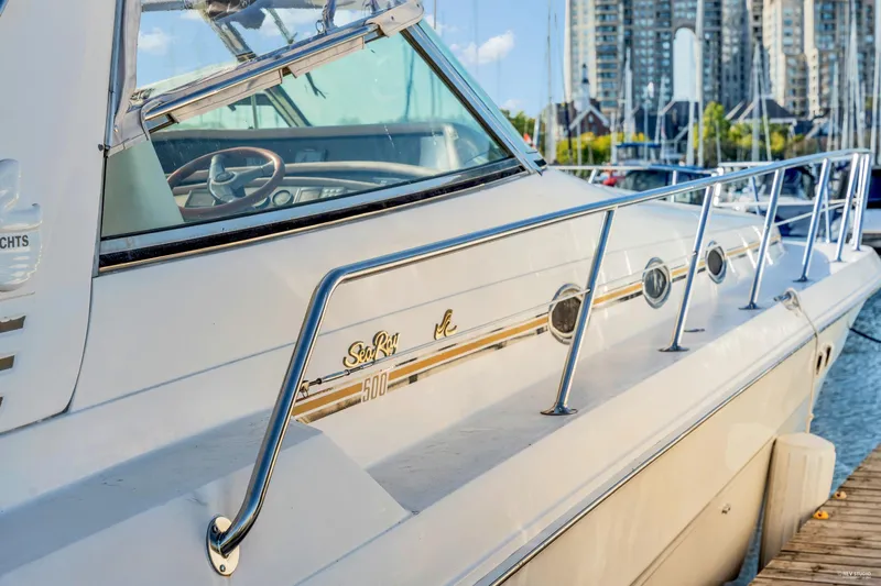  Yacht Photos Pics 1997 Sea Ray 500 Sundancer yacht docked at marina with cityscape background.