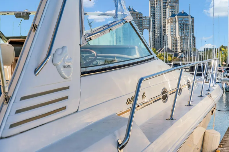  Yacht Photos Pics 1997 Sea Ray 500 Sundancer yacht docked at marina with cityscape background.