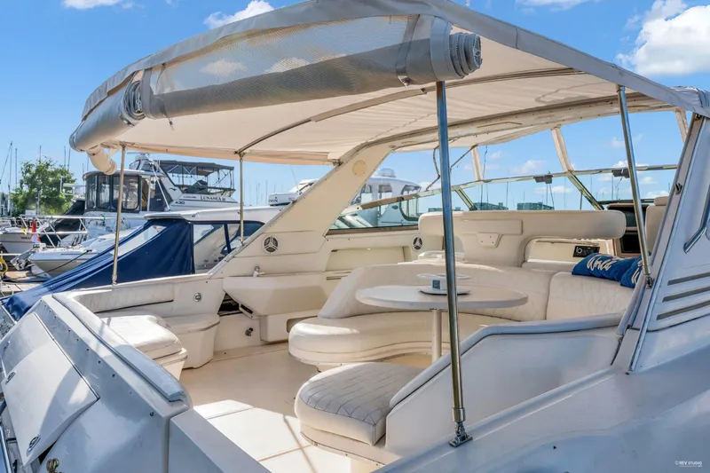  Yacht Photos Pics 1997 Sea Ray 500 Sundancer yacht with spacious seating and canopy, docked at marina.