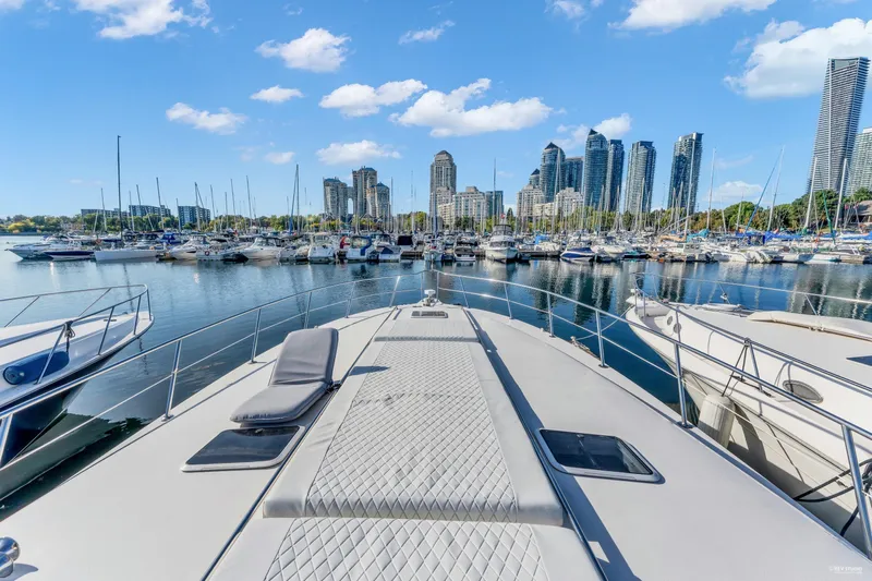  Yacht Photos Pics 1997 Sea Ray 500 Sundancer yacht docked in a marina with city skyline backdrop.