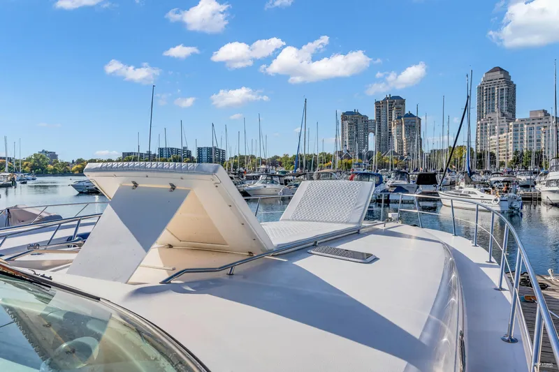  Yacht Photos Pics 1997 Sea Ray 500 Sundancer yacht docked in a marina with city skyline.