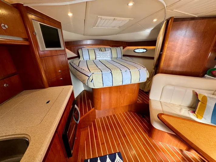  Yacht Photos Pics 2006 Tiara Yachts 3200 Open cabin interior with bed, kitchenette, and seating area.