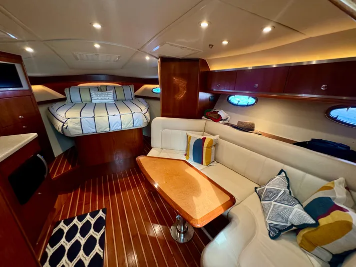  Yacht Photos Pics Luxurious interior of 2006 Tiara Yachts 3200 Open with cozy seating and elegant wood finishes.