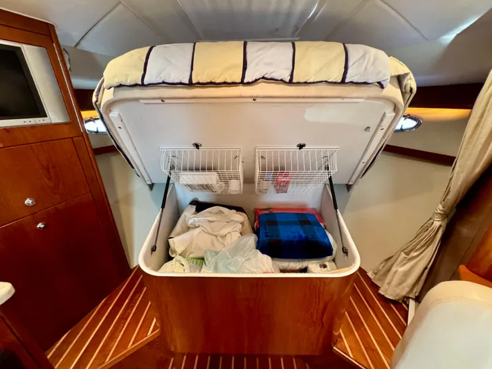  Yacht Photos Pics 2006 Tiara Yachts 3200 Open cabin with under-bed storage, wooden interior, and cozy bedding.