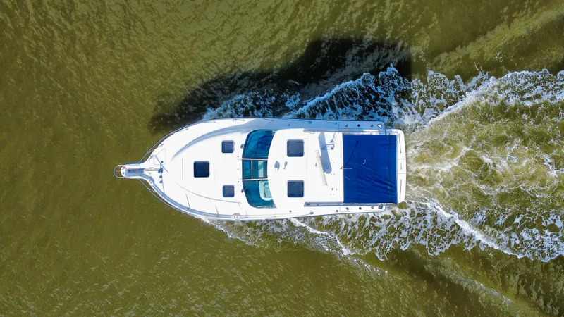  Yacht Photos Pics Aerial view of 2006 Tiara Yachts 3200 Open cruising on water.