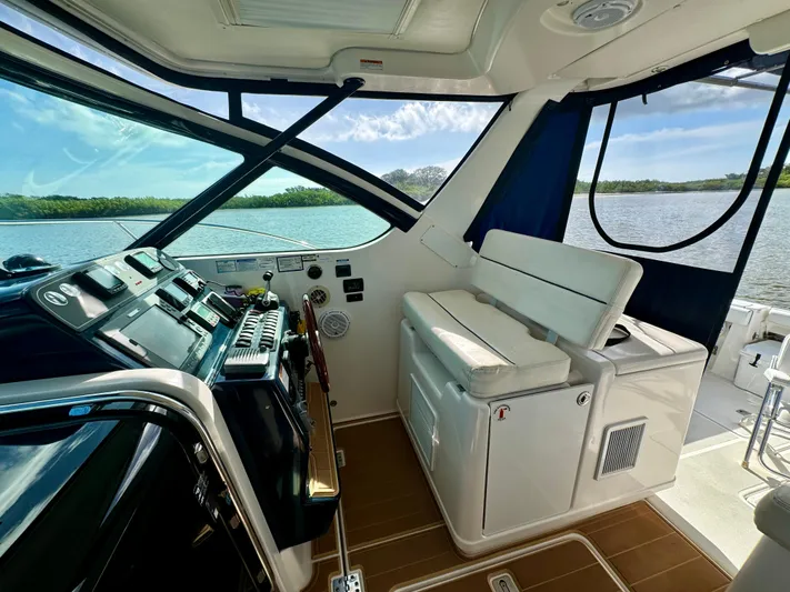  Yacht Photos Pics 2006 Tiara Yachts 3200 Open cockpit with helm, seating, and scenic water view.