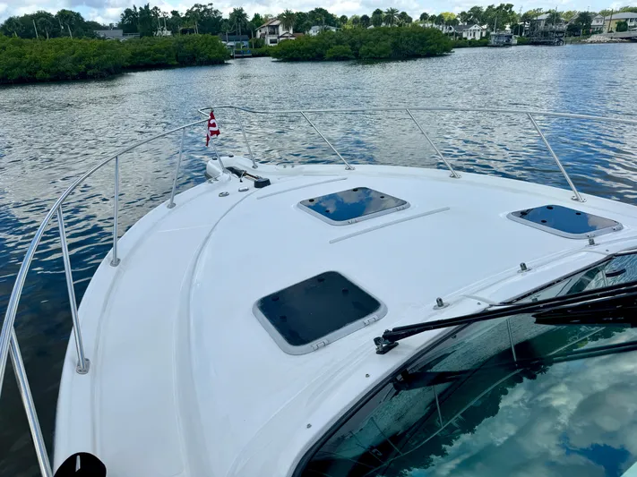  Yacht Photos Pics 2006 Tiara Yachts 3200 Open on calm water, showcasing sleek deck design.