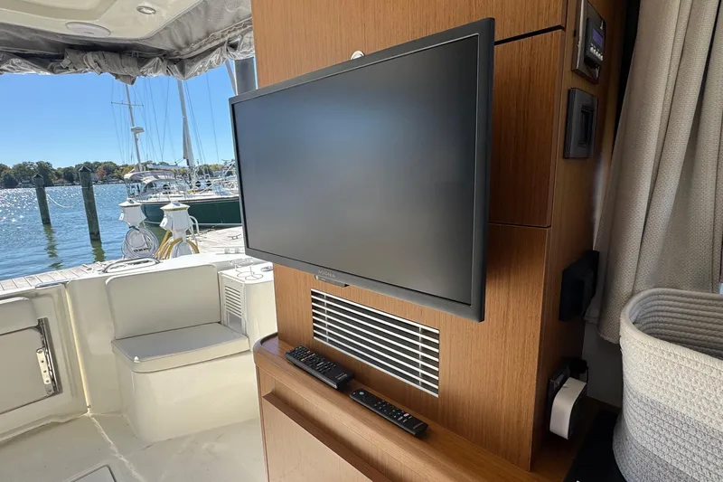 R&r Yacht Photos Pics Interior of 2023 Beneteau Swift Trawler 35 with TV and marina view.