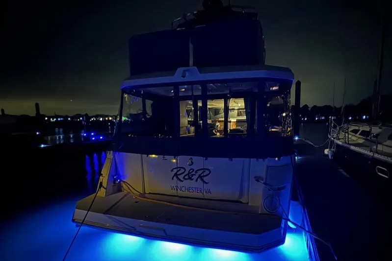 R&r Yacht Photos Pics 2023 Beneteau Swift Trawler 35 with blue underwater lights at night.