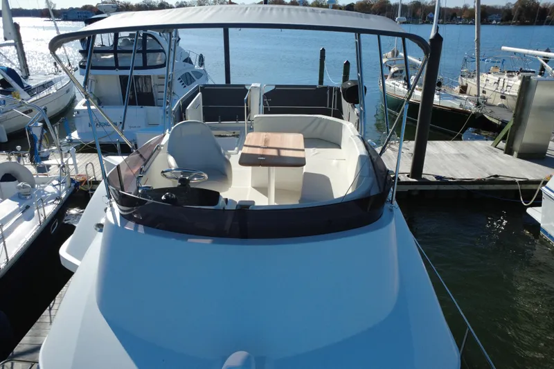 R&r Yacht Photos Pics 2023 Beneteau Swift Trawler 35 docked, showcasing spacious deck and seating area.