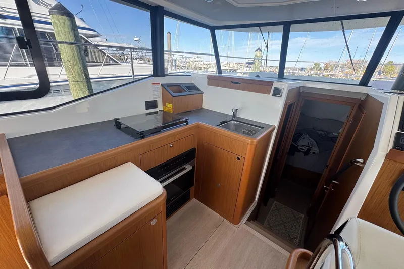 R&r Yacht Photos Pics 2023 Beneteau Swift Trawler 35 interior with kitchen, sink, and cabin view.