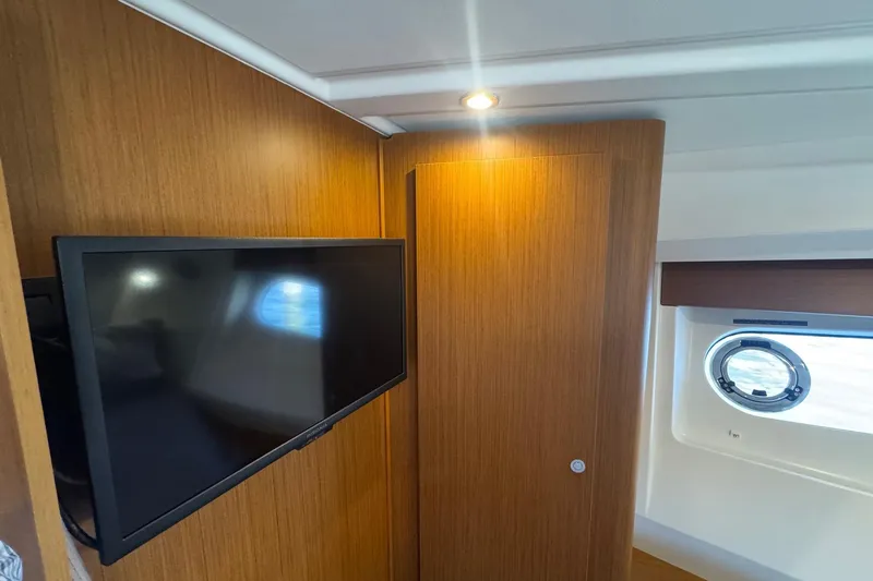 R&r Yacht Photos Pics 2023 Beneteau Swift Trawler 35 interior with TV and porthole window.