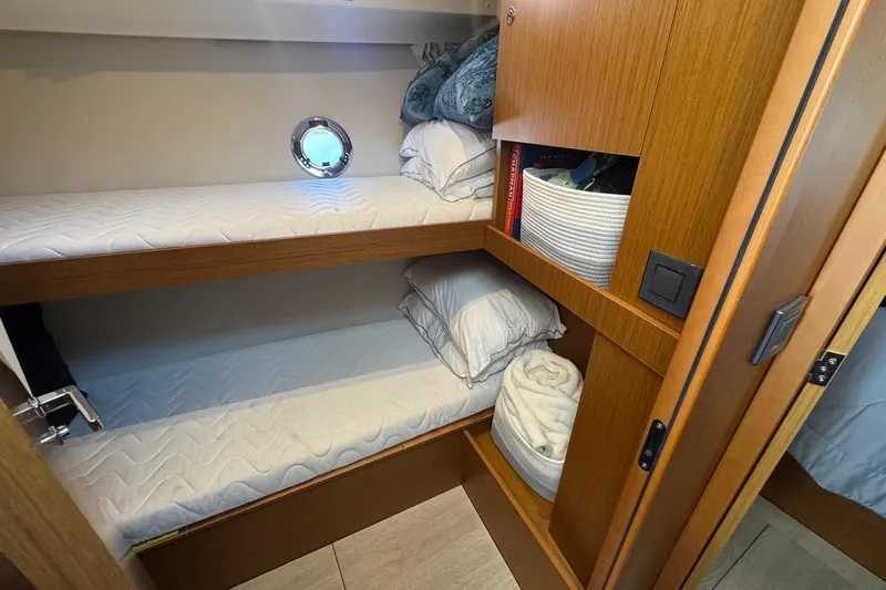 R&r Yacht Photos Pics 2023 Beneteau Swift Trawler 35 cabin with bunk beds and storage shelves.