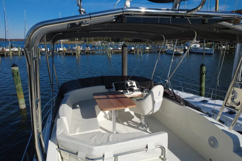 R&r Yacht Photos Pics 2023 Beneteau Swift Trawler 35, spacious deck with seating, docked at marina.
