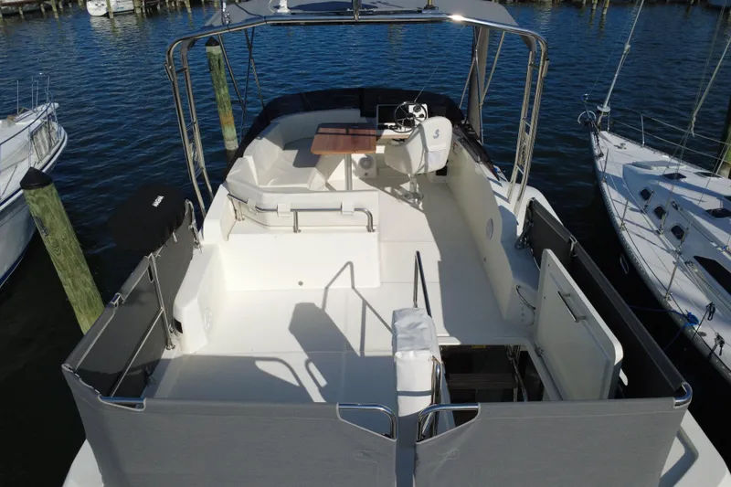 R&r Yacht Photos Pics 2023 Beneteau Swift Trawler 35, spacious deck view, docked at marina.