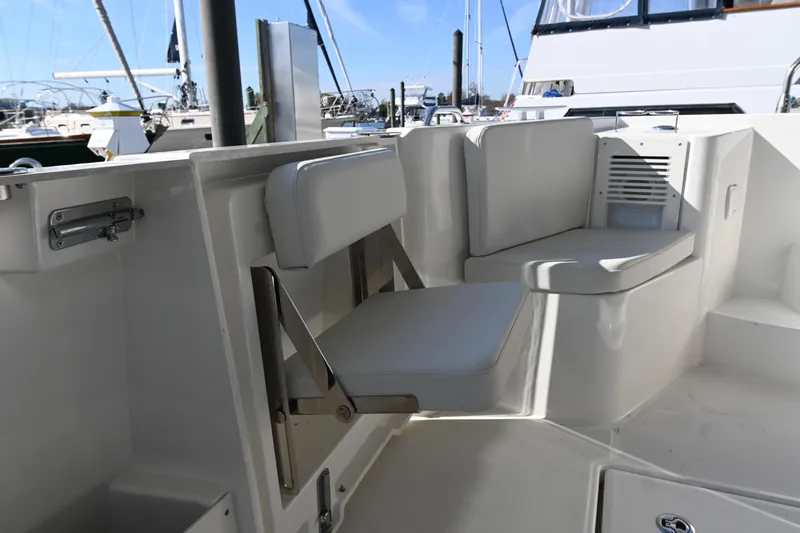 R&r Yacht Photos Pics 2023 Beneteau Swift Trawler 35 interior seating area with white cushions.
