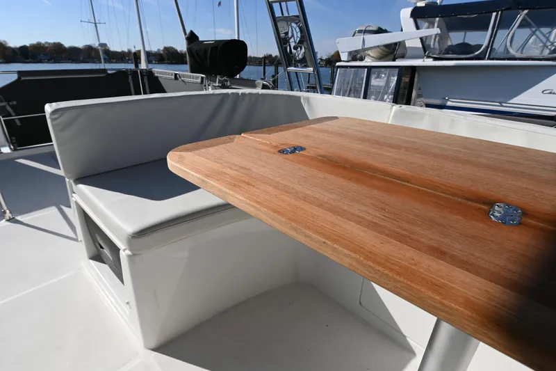 R&r Yacht Photos Pics 2023 Beneteau Swift Trawler 35 deck with wooden table and cushioned seating.