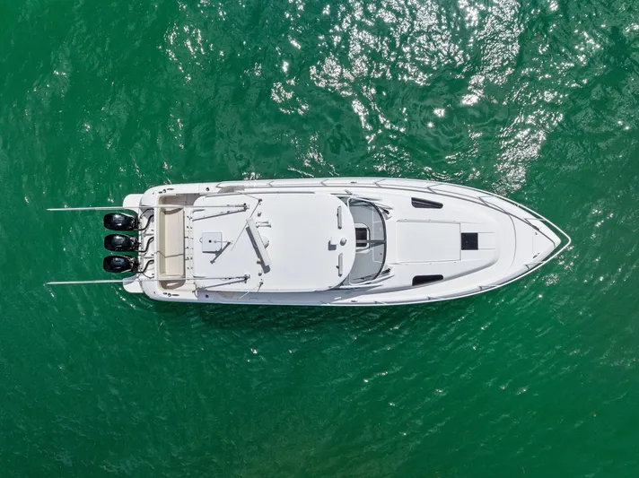 Virgo Yacht Photos Pics Aerial view of 2018 Intrepid 430 Sport Yacht on clear green water.