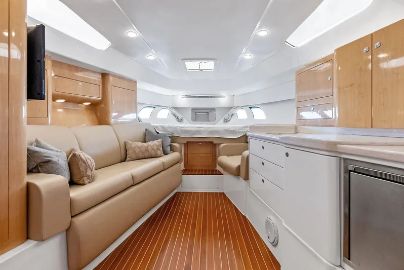 Virgo Yacht Photos Pics Luxurious interior of 2018 Intrepid 430 Sport Yacht with modern furnishings and wood accents.