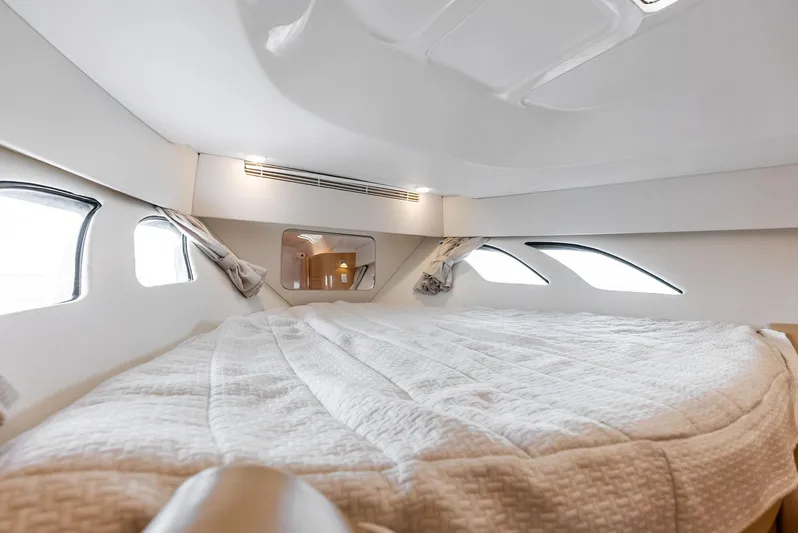 Virgo Yacht Photos Pics Luxurious cabin interior of 2018 Intrepid 430 Sport Yacht with cozy bedding and windows.