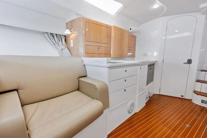 Virgo Yacht Photos Pics Interior of 2018 Intrepid 430 Sport Yacht with beige seating and modern kitchenette.