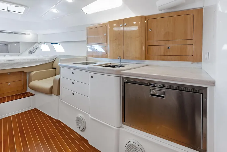 Virgo Yacht Photos Pics 2018 Intrepid 430 Sport Yacht interior with modern kitchen, wood cabinets, and sleek design.