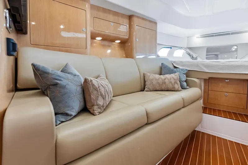 Virgo Yacht Photos Pics Luxurious interior of 2018 Intrepid 430 Sport Yacht with beige sofa and decorative pillows.