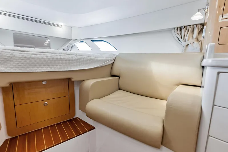 Virgo Yacht Photos Pics 2018 Intrepid 430 Sport Yacht interior with beige seating and wooden drawers.