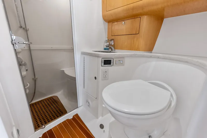 Virgo Yacht Photos Pics Bathroom interior of 2018 Intrepid 430 Sport Yacht with shower and toilet.