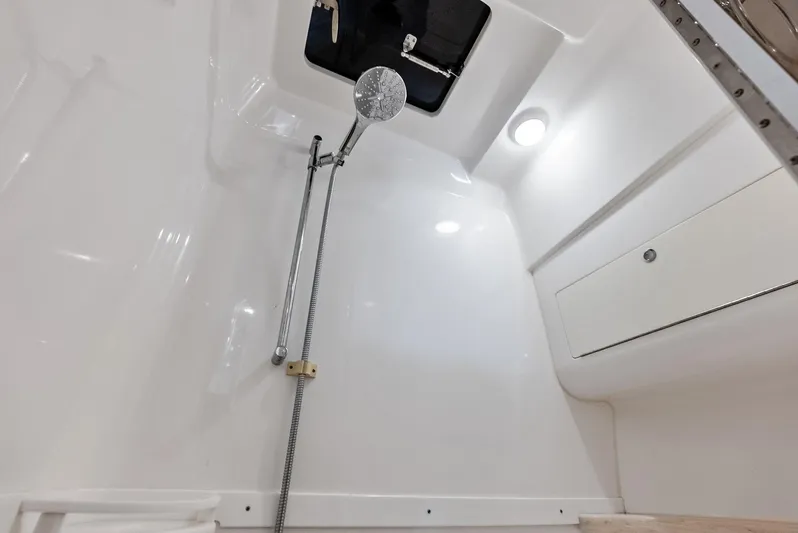 Virgo Yacht Photos Pics Interior shower of 2018 Intrepid 430 Sport Yacht, featuring sleek white design and modern fixtures.