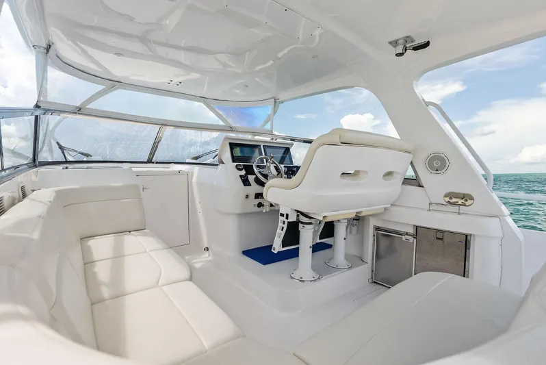 Virgo Yacht Photos Pics 2018 Intrepid 430 Sport Yacht interior with white seating and helm, overlooking ocean.