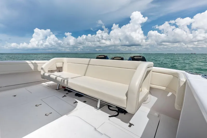 Virgo Yacht Photos Pics 2018 Intrepid 430 Sport Yacht deck with seating, ocean view, and blue sky.