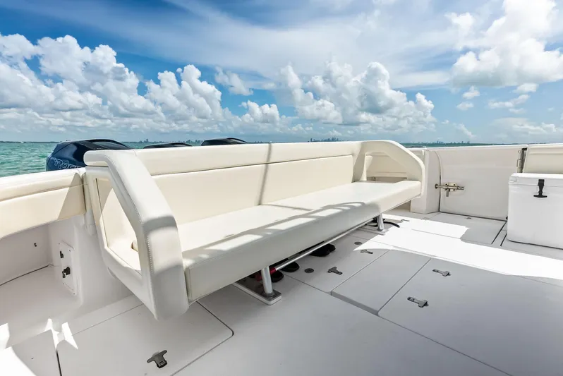 Virgo Yacht Photos Pics 2018 Intrepid 430 Sport Yacht deck with seating, ocean view, and clear skies.
