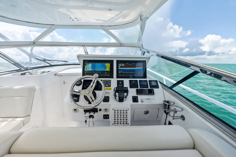 Virgo Yacht Photos Pics Cockpit view of 2018 Intrepid 430 Sport Yacht with navigation screens and steering wheel.