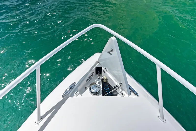 Virgo Yacht Photos Pics Bow view of 2018 Intrepid 430 Sport Yacht on clear turquoise water.