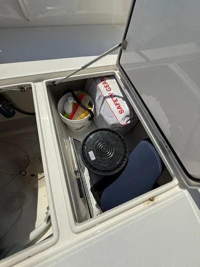  Yacht Photos Pics Storage compartment on 2018 Jupiter 26 FS boat with safety gear and supplies.