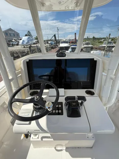  Yacht Photos Pics 2018 Jupiter 26 FS boat helm with steering wheel and navigation controls.