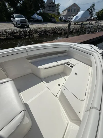  Yacht Photos Pics 2018 Jupiter 26 FS boat interior with seating and storage, docked near waterfront.