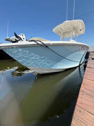  Yacht Photos Pics 2018 Jupiter 26 FS boat docked, reflecting sunlight on calm water.