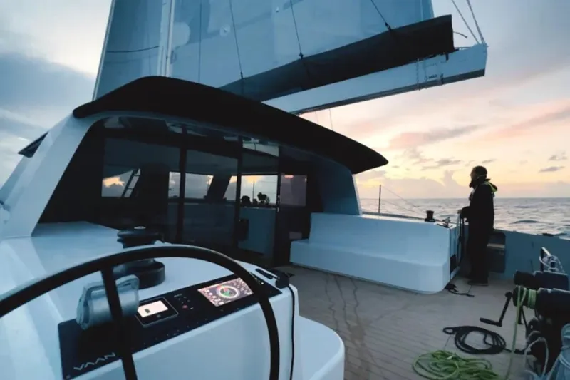  Yacht Photos Pics Sailing yacht Vaan R4, 2025 model, at sunset with person on deck.