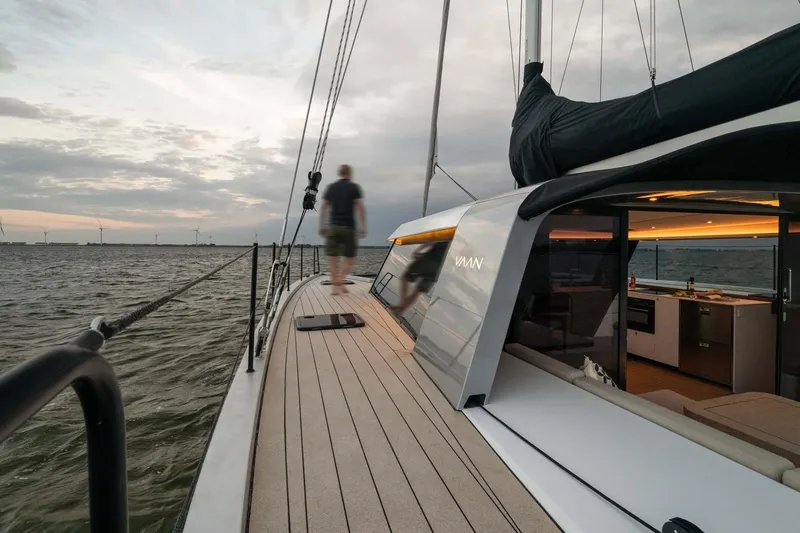  Yacht Photos Pics Sleek Vaan R4 yacht sailing at sunset, showcasing modern design and luxury.