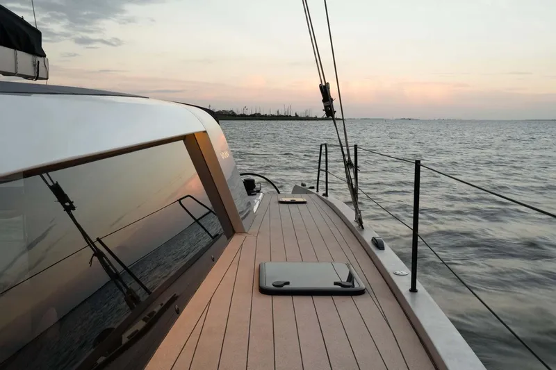  Yacht Photos Pics Sleek Vaan R4 yacht sailing at sunset, 2025 model, reflecting serene ocean views.